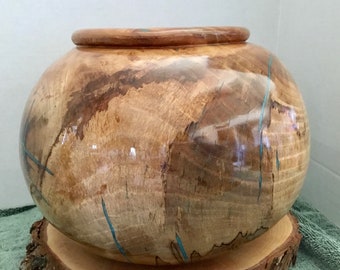 This is a Spalded Pecan Wood bowl with Turquoise Inlay, it is 7 1/2” tall by 10 1/2” wide