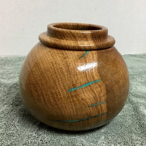 This is an Oak bowl with Turquoise Inlay, it is 5 3/4” wide by 5 1/4” tall