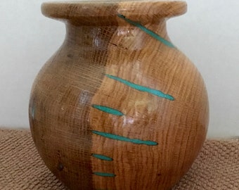 This is a wood bowl out of pecan with turquoise Inlay, it is 5” tall  by 4 3/4” wide
