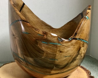 This is a Pitachio bowl with Turquoise Inlay, It is 8 1/2” tall by 8’ wide