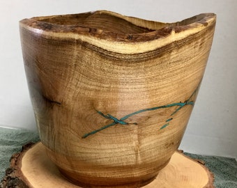 This is a Mesquite Bowl (vase) with Turquoise Inlay, it is 8” tall by 8 3/4” wide