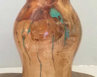 This is a Birds Eye Juniper Burl Bowl with Turquoise Inlay, it is 9” tall x 7 1/2” wide.