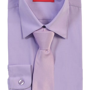 May include: A lavender dress shirt with a matching lavender tie. The shirt has a button-down collar and long sleeves. The label on the shirt reads "AFT COLLECTION".