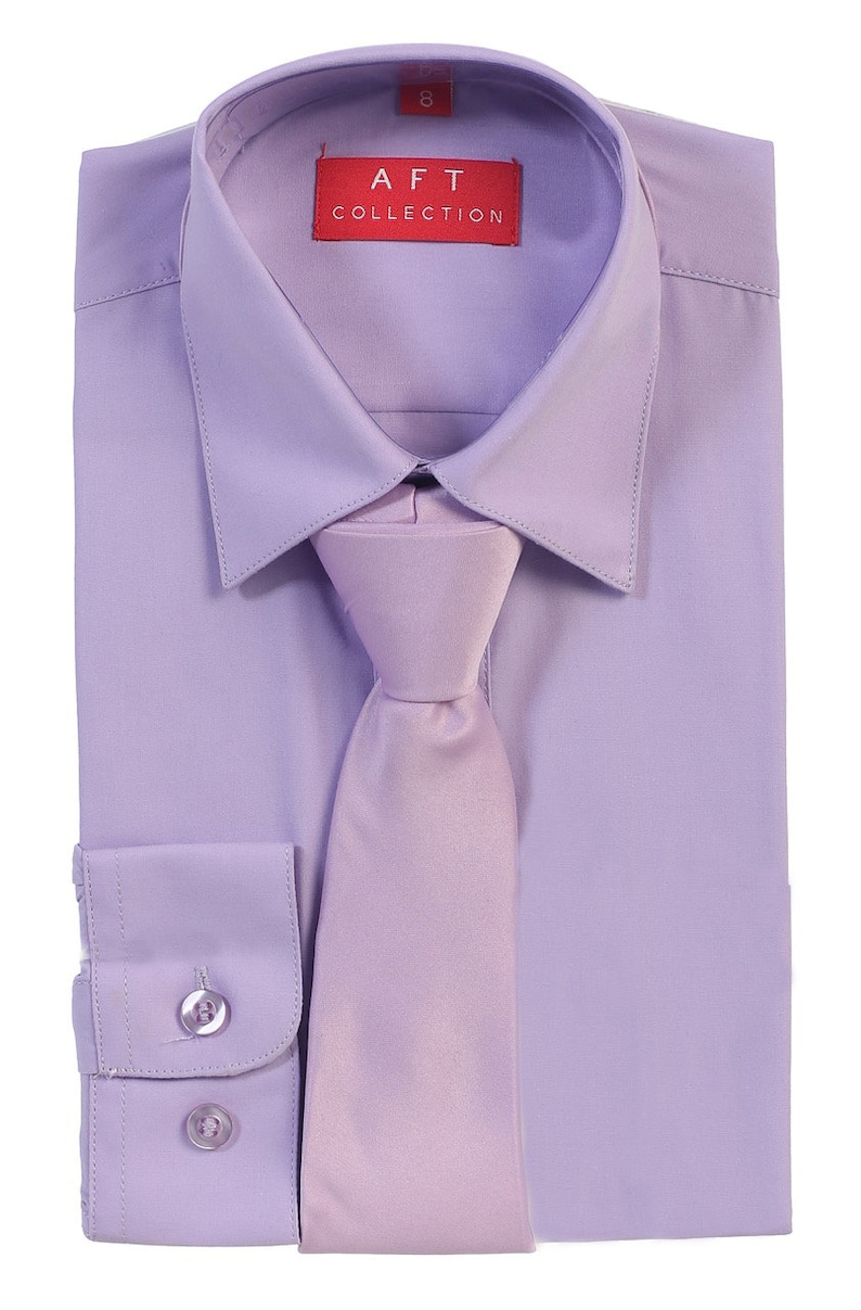 May include: A lavender dress shirt with a matching lavender tie. The shirt has a button-down collar and long sleeves. The label on the shirt reads "AFT COLLECTION".