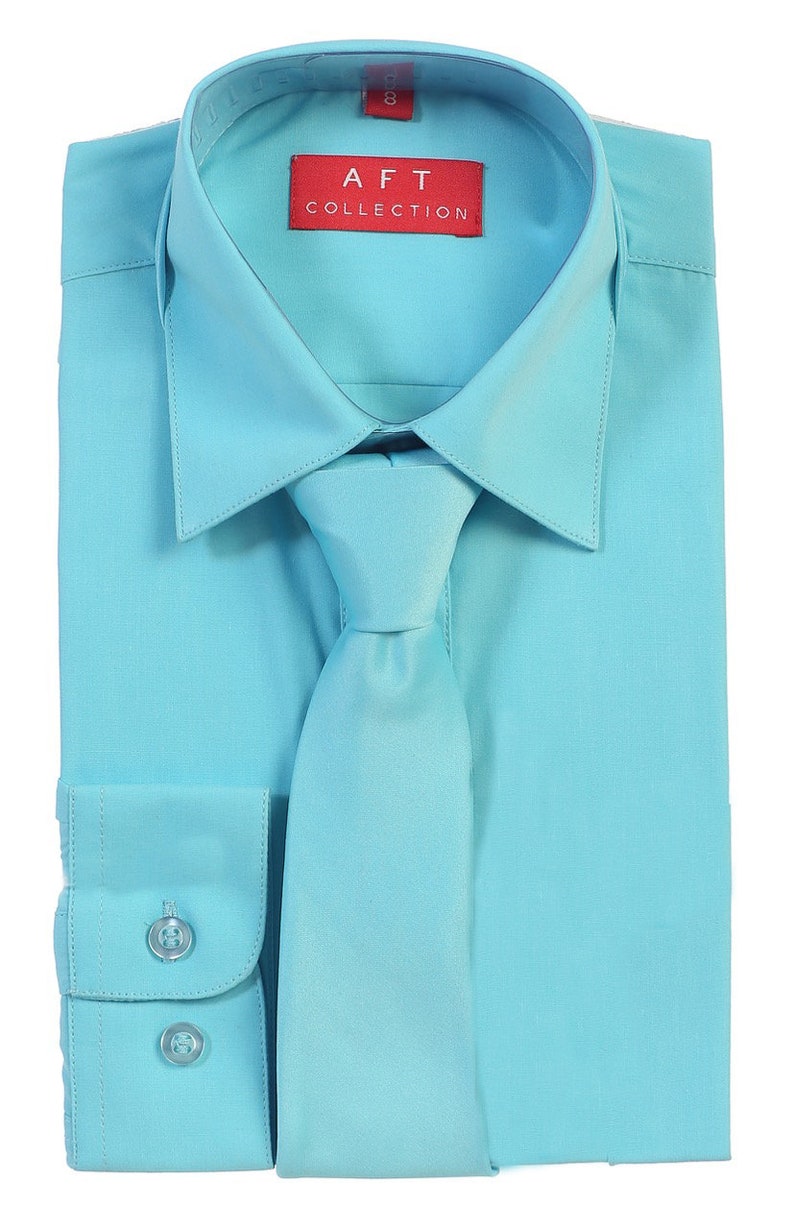 May include: A light blue dress shirt with a matching tie. The shirt has a button-down collar and long sleeves. The label on the shirt reads "AFT COLLECTION".