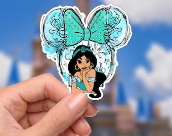 May include: A sticker featuring Princess Jasmine from Aladdin, with a Mickey Mouse ear design. The sticker has a teal bow with white polka dots, and a blue watercolor background. The princess has black hair and is wearing a teal outfit.