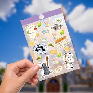 May include: A sheet of colorful stickers featuring culinary-themed illustrations. Designs include a chef rat, cooking utensils, food items, and text bubbles with phrases like "Bon Appétit!" and "Order Up!" The stickers have a light purple border.