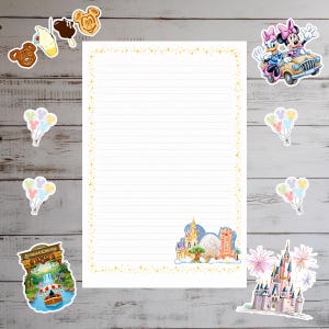 May include: A rectangular sheet of lined stationery paper with a gold star border. The bottom right corner features a colorful illustration of a castle and a geodesic dome. Surrounding the paper are various stickers including Mickey-shaped treats, balloons, a Jungle Cruise boat, a car with cartoon characters, and a castle with fireworks.