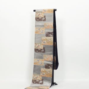 Può includere: Una tazza di ceramica bianca con un manico nero e la scritta "But First, Coffee" in nero, con un carattere a mano. La tazza è su una superficie bianca.