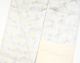 May include: A white silk fabric with a silver pattern of fans. The fabric is folded in half and the pattern is visible on both sides.
