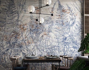 Könnte beinhalten: Ein Esszimmer mit einer Wandtapete, die blaue botanische Farn- und Rankenillustrationen auf strukturiertem beigem Hintergrund zeigt. Ein rechteckiger Holztisch mit vier Stühlen steht vor der Wand, beleuchtet von einer schwarzen Pendelleuchte.