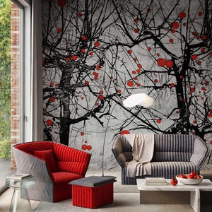 May include: A living room featuring a wall mural with black tree silhouettes and red circular accents. The furniture includes a red and gray armchair, a matching ottoman, a gray sofa with a beige throw, a glass side table, and a marble coffee table.
