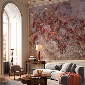 May include: A living room with a gray sectional sofa, two wooden coffee tables, and a floral mural. A brown armchair and a side table with a lamp are also present. The room has a modern design with a neutral color palette and a decorative light fixture.