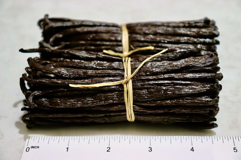 May include: A bundle of dried vanilla beans tied together with twine, measuring approximately 3 inches in length.