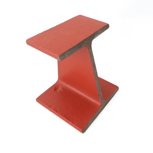 May include: A red metal I-beam, a structural component used in construction.
