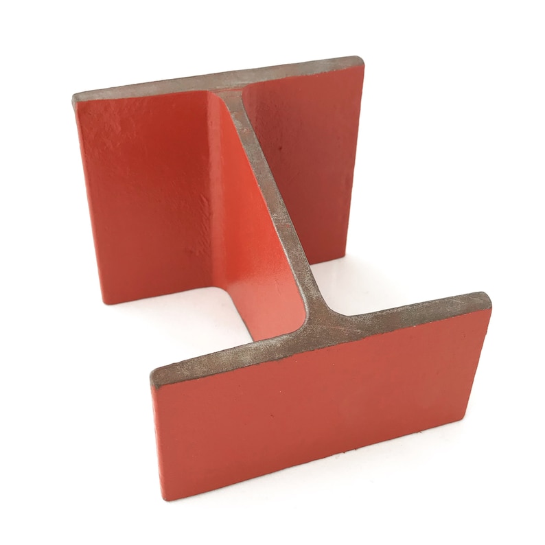 May include: A red metal I-beam, a structural component used in construction.