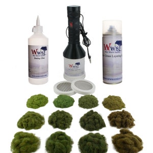 May include: A set of tools and materials for creating realistic grass and foliage on model landscapes. The set includes a glue bottle, a grass applicator, a spray can, and a variety of green and brown grass tufts.