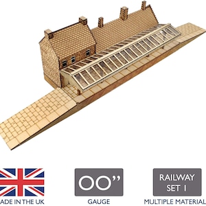 May include: A wooden model kit of a railway station with a glass roof. The kit is made of multiple materials and is for OO gauge. The kit is made in the UK.