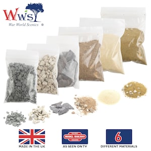May include: Six bags of different colored and textured model railroad scenery materials. The bags are labeled "Wws War World Scenics". The materials include gray gravel, white gravel, black slate, brown dirt, beige sand, and tan sand. The image also shows a small pile of each material outside of the bags. The image includes the text "The Great Model Railway Challenge" and "As Seen On TV".