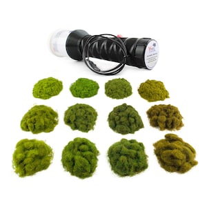 May include: A black and white model railroad applicator tool with a black handle and a red button, and a collection of green and brown model railroad foliage. The applicator has the text "WWS" on it.
