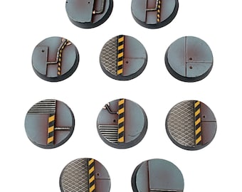 May include: Ten round, gray and black plastic bases with different industrial designs. The bases feature yellow and black warning stripes, metal grates, and pipes.