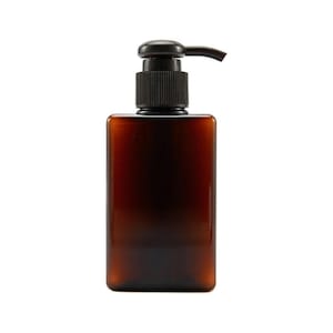 May include: A brown glass bottle with a black pump dispenser. The bottle is rectangular and has a frosted finish.