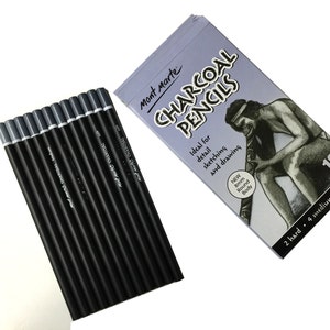 May include: A set of twelve Mont Marte charcoal pencils with black barrels and grey ends, accompanied by a rectangular box featuring the text "Mont Marte CHARCOAL PENCILS", an illustration of a person playing a didgeridoo, and "12 PIECES".