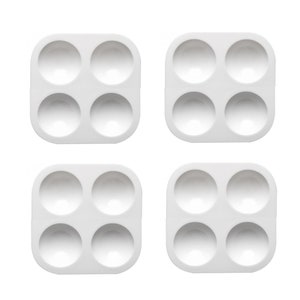 May include: Four white plastic paint palettes with four round wells each. The palettes are arranged in a two by two grid.