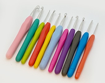 Può includere: Un set di undici uncinetti con manici in silicone colorati in rosa, verde acqua, verde lime, rosso, giallo, azzurro, magenta, viola, nero, blu e arancione. Ogni uncinetto in metallo presenta una misura stampata sul manico.