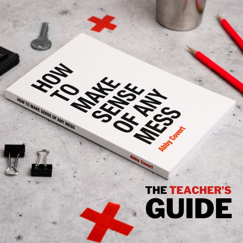 May include: A white book with black text that reads "How to Make Sense of Any Mess" by Abby Covert. The book is on a gray surface with red plus signs and a silver cup. The text "The Teacher's Guide" is below the book.