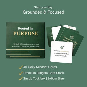 Op de afbeelding: Een set dagelijkse affirmatiekaarten in een groene doos met de tekst "Rooted in Purpose". De kaarten zijn wit met groene tekst en afbeeldingen. De doos en kaarten staan op een groene achtergrond. De doos meet 9x9cm.