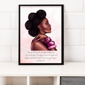 May include: A framed art print featuring a side profile of a Black woman with dark hair styled in a bun. She wears pink earrings and bracelets. The print includes the text "You are clothed with strength and dignity... Proverbs 31:25-26."