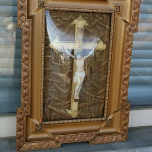 Antique french religious frame with chalk christ crucifix inside behind glass