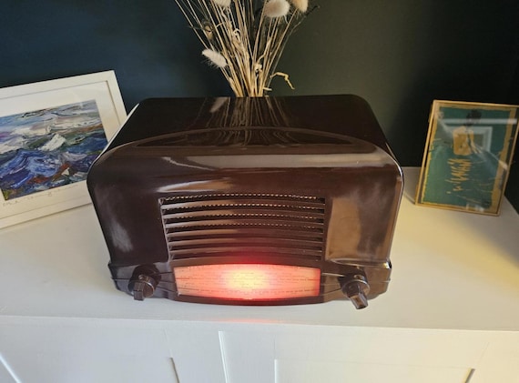 A genuine vintage Cossor Bakelite radio cabinet gutted and reborn as a Bluetooth speaker — the dial still glows, the past meets your Spotify playlist.