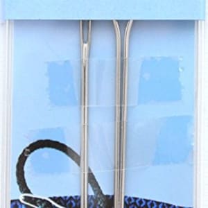 May include: Two silver bodkins, also known as tapestry needles, are displayed on a blue and white patterned background. The packaging includes the product code H231320 and the text "2 Bodkins".