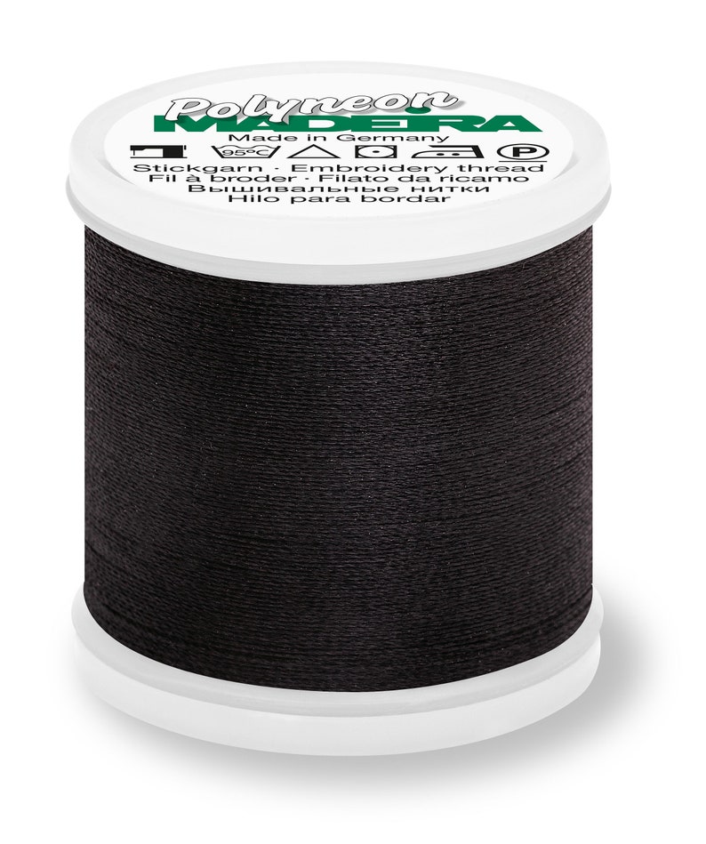May include: A spool of black embroidery thread labeled "Polyneon Made in Germany 95&deg;C  △□▽□P Stickgarn Embroidery thread Fil &agrave; broder Filato da ricamo Вышивальные нитки Hilo para bordar"