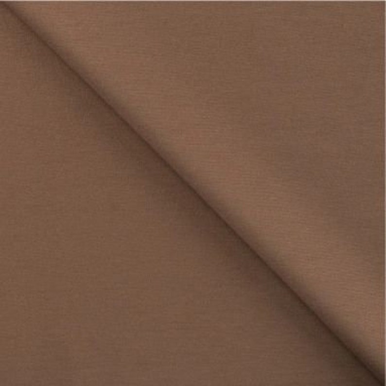 May include: A solid brown fabric swatch. The fabric has a smooth, even texture.
