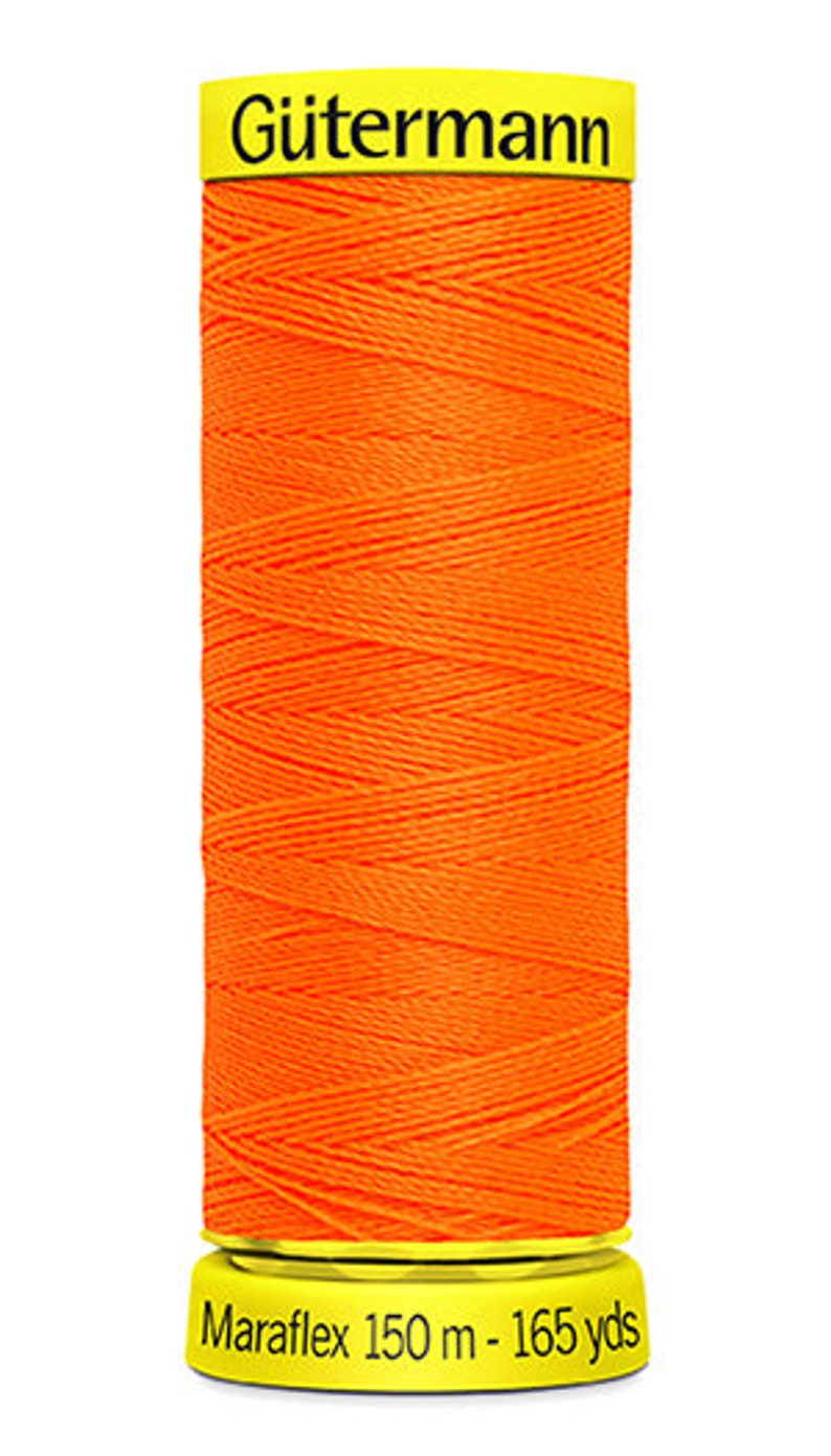 May include: A spool of orange G&uuml;termann Maraflex thread with a yellow label. The label reads "G&uuml;termann Maraflex 150 m - 165 yds".