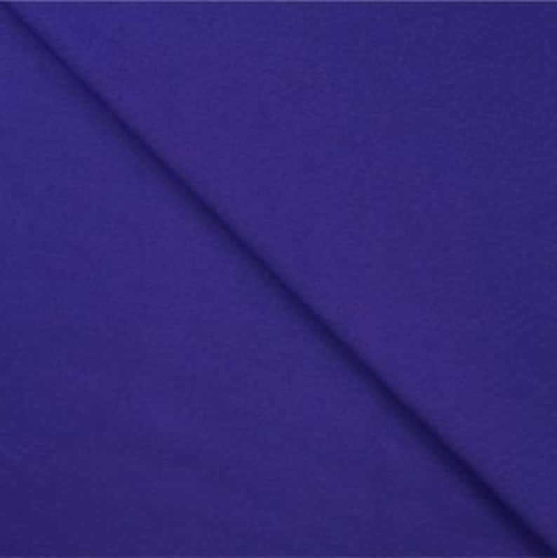 May include: Solid purple fabric swatch. The fabric has a smooth, even texture.
