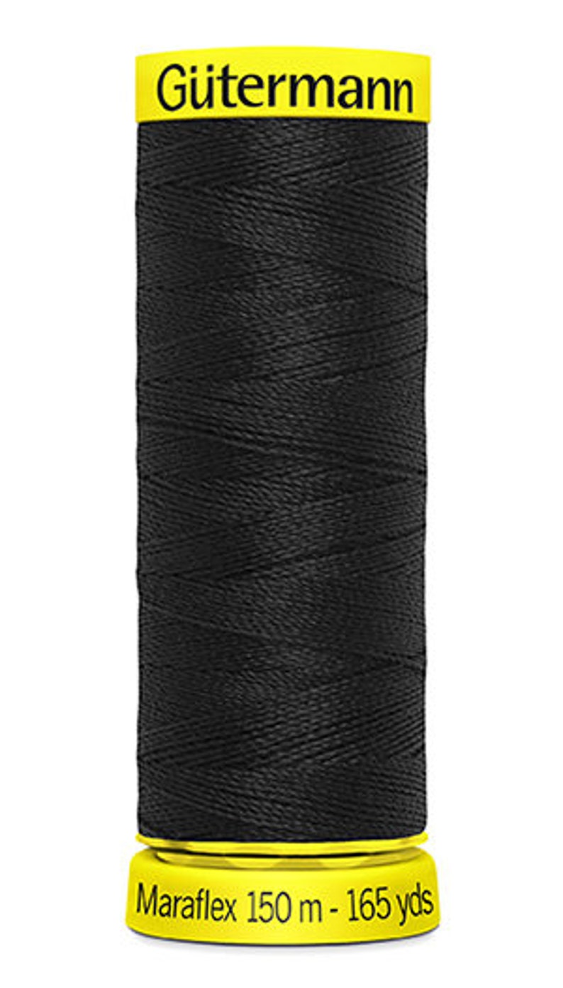 May include: A spool of black G&uuml;termann Maraflex thread with a yellow label. The label reads "G&uuml;termann Maraflex 150 m - 165 yds".