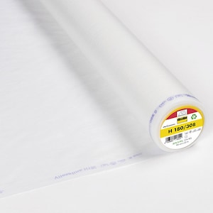 Può includere: Un rotolo bianco di interfodera termoadesiva con un'etichetta gialla che recita "H 180/308".