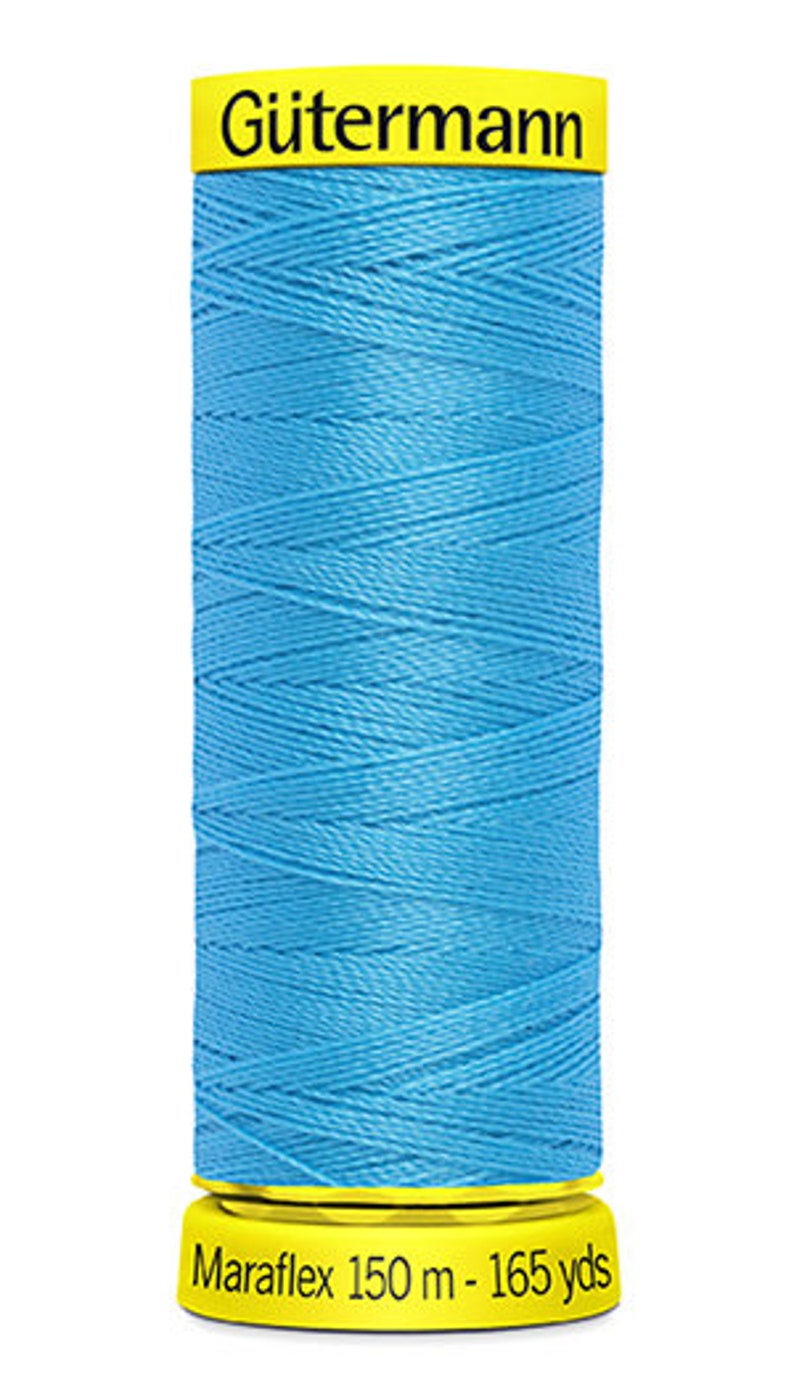 May include: A spool of G&uuml;termann Maraflex thread in a bright blue color. The spool is labeled with the brand name and the length of the thread: 150 m - 165 yds.