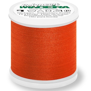 May include: A spool of orange embroidery thread labeled "Polyneon Madeira" with the text "Made in Germany" and care instructions.