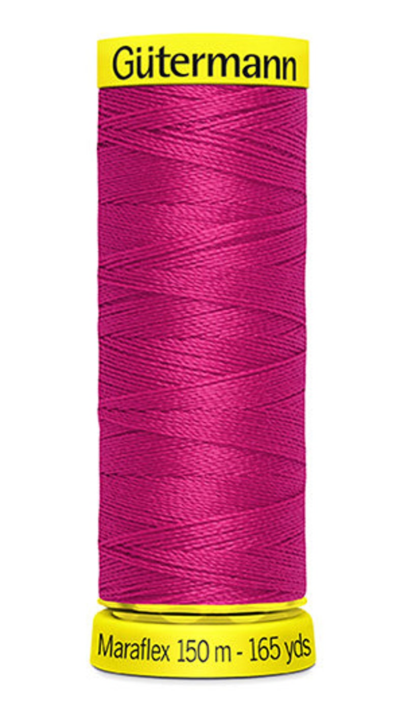 May include: A spool of pink G&uuml;termann Maraflex thread with a yellow label. The label reads "G&uuml;termann Maraflex 150 m - 165 yds".