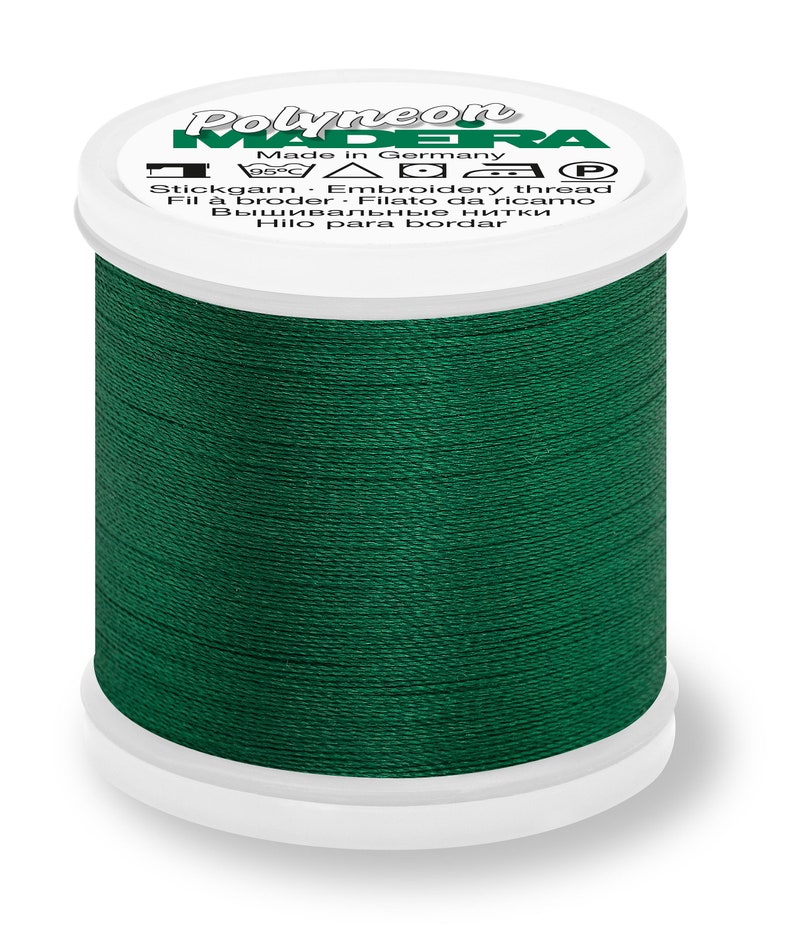 May include: A spool of dark green embroidery thread labeled "Polyneon Madeira" with the text "Made in Germany" and "Stickgarn. Embroidery thread. Fil &agrave; broder. Filato da ricamo. Вышивальные нитки. Hilo para bordar".