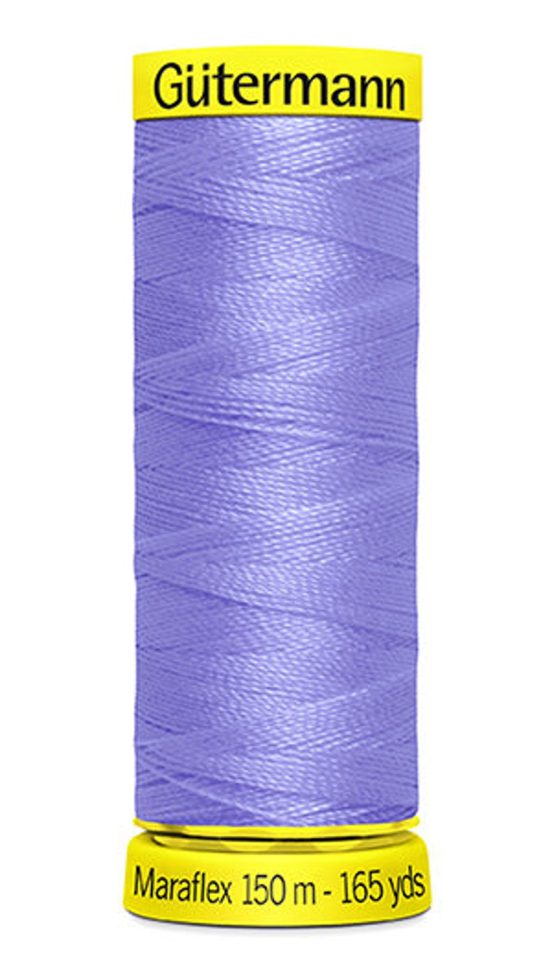 May include: A spool of G&uuml;termann Maraflex thread in a light purple color. The spool is labeled "G&uuml;termann Maraflex 150 m - 165 yds".