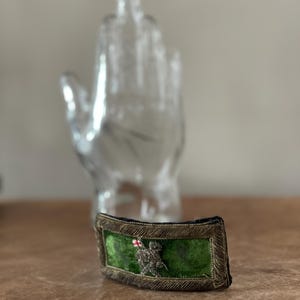 May include: A white ceramic mug with a black handle and the text "But First, Coffee" in a bold, black font. The mug is set against a neutral background, highlighting its simple design.