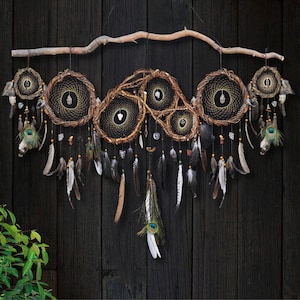 May include: A large wall hanging featuring multiple circular dream catchers woven with dark thread and brown twigs, suspended from a natural wooden branch. The piece is adorned with various hanging feathers, including peacock feathers, and small crystals.