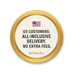 May include: A circular gold-rimmed sign with a cream-colored center featuring a small American flag icon above the black text: US CUSTOMERS: ALL-INCLUSIVE DELIVERY. NO EXTRA FEES. The word ARMONIZAR is printed at the bottom in multicolored letters.
