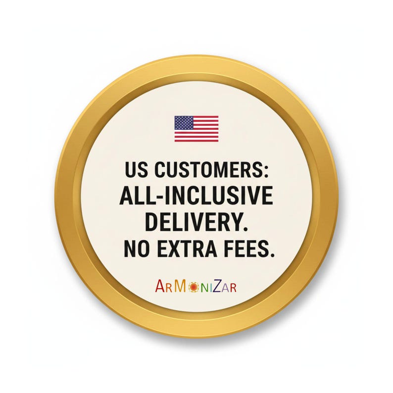 May include: A circular gold-rimmed sign with a cream-colored center featuring a small American flag icon above the black text: US CUSTOMERS: ALL-INCLUSIVE DELIVERY. NO EXTRA FEES. The word ARMONIZAR is printed at the bottom in multicolored letters.